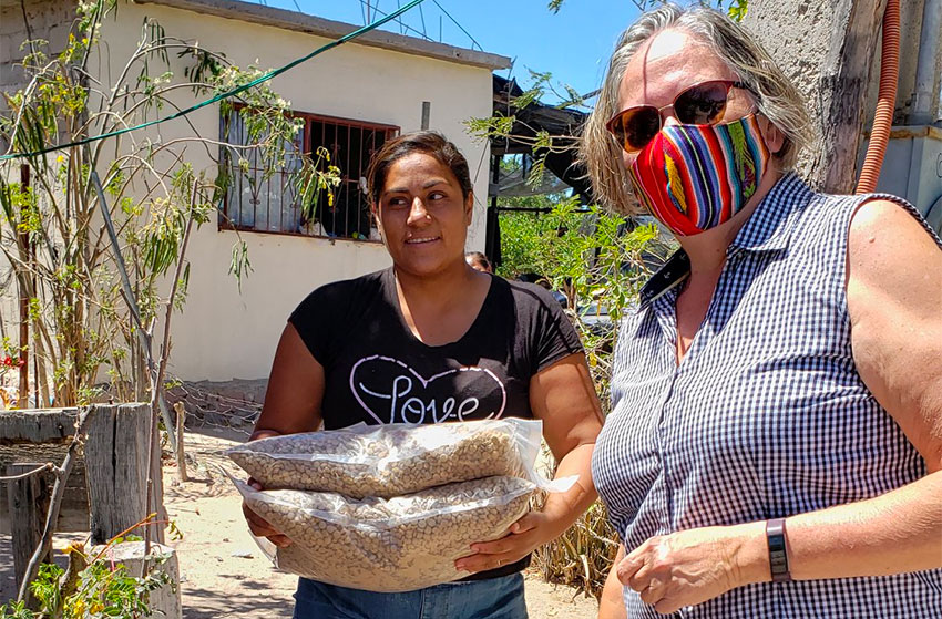 A Food for Families recipient with donated supplies in La Paz, Baja California Sur.