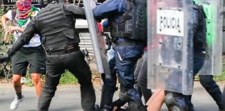 Police put their boots to a 16-year-girl in Mexico City.