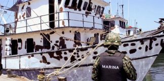 A marine conducts vessel inspections.