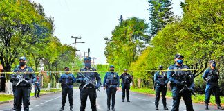 Police guard the crime scene Friday in Mexico City.