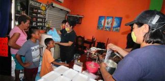 Staff at La Posta hand out meals to needy neighbors in Tampico.