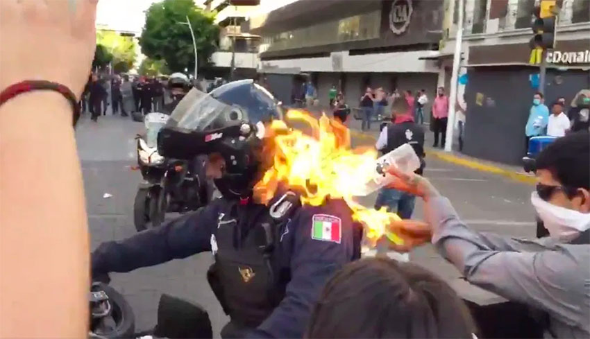 A police officer was set on fire during the protest on Thursday.