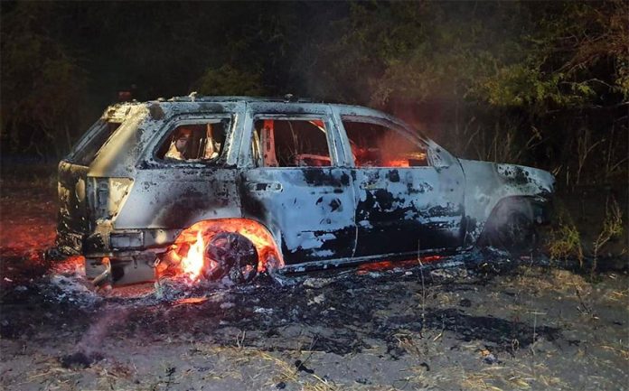 A car burns north of Culiacán where cartel hitmen have been fighting among themselves.