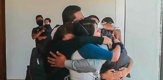 Tolentino receives a warm embrace from family members.