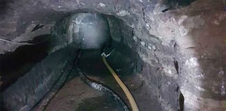 Hoses transport fuel in a petroleum thieves' tunnel.
