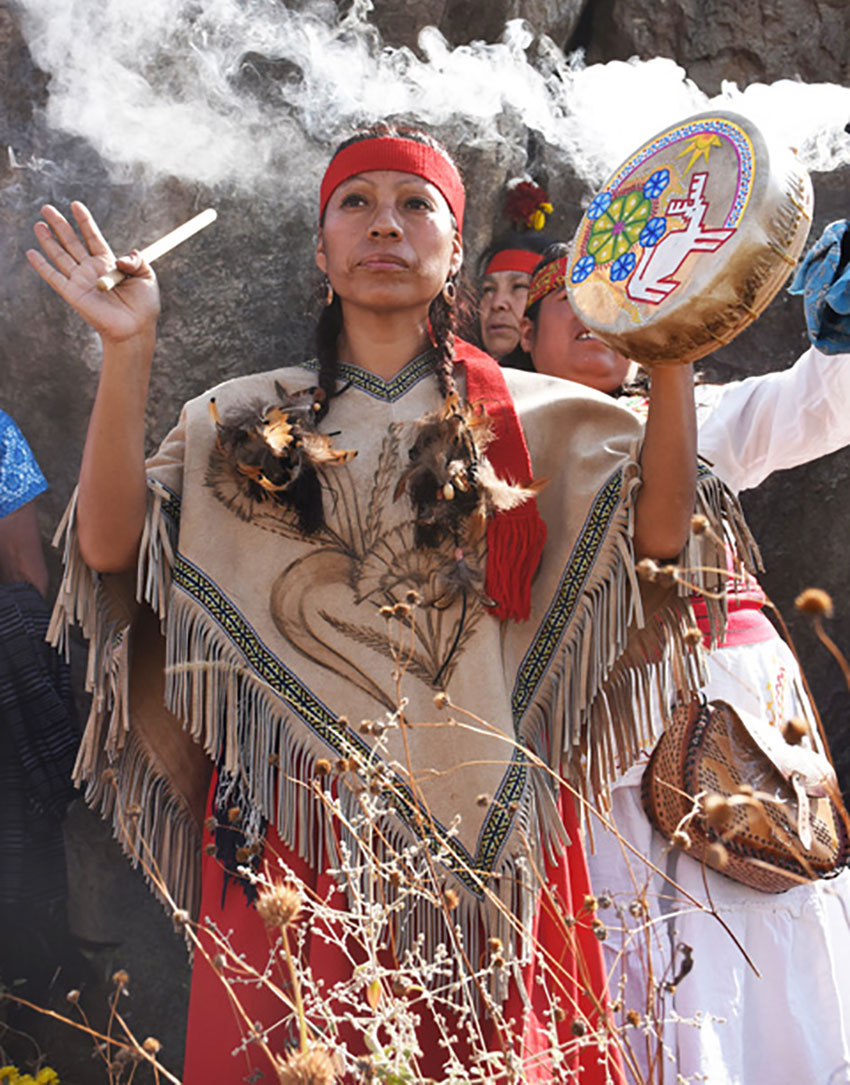 A curandera, or healer, performs a ceremony at the monoliths.