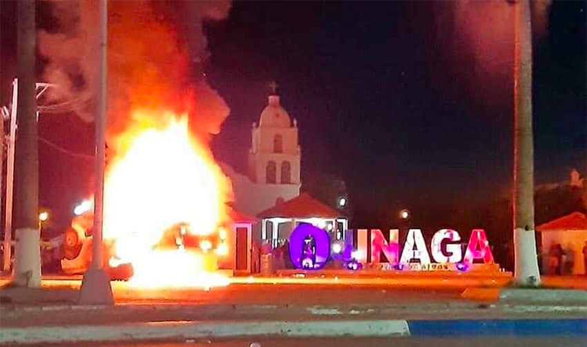 Protesters set fire to a vehicle during a protest Tuesday in Ojinaga.