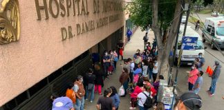Family members wait outside La Raza National Medical Center in Mexico City for news about relatives inside.