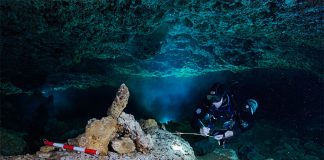 A diver examines a rock pile believed to be a navigational marker in the ocher mine.