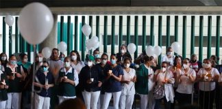 Hospital staff at the ceremony for coronavirus victim.