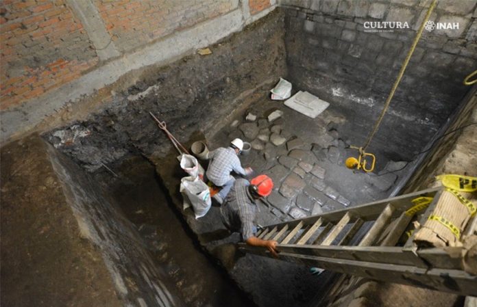 Archaeologists excavate and clean stone floor dating back to the early 16th century