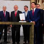 Officials celebrate the new pension reform Wednesday at the National Palace