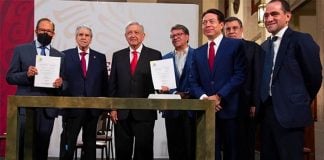 Officials celebrate the new pension reform Wednesday at the National Palace