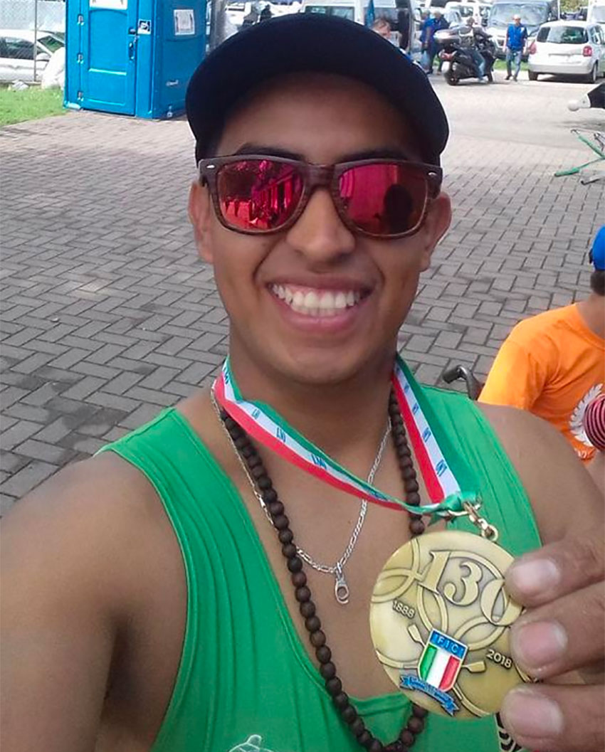 Ramírez shows off a rowing medal.