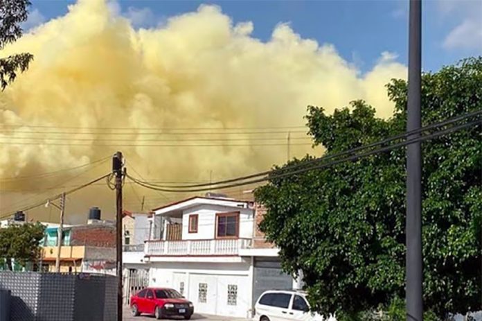 Yellow smoke above homes in Salamanca Thursday.