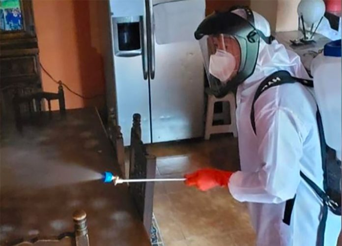 A home in which occupants were diagnosed with Covid-19 is disinfected in Xochimilco, Mexico City.