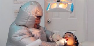 Odontologist Adela Rendón demonstrates the new suit.