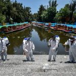 Workers disinfect a walkway in Xochimilco, Mexico City.