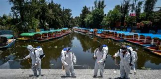 Workers disinfect a walkway in Xochimilco, Mexico City.