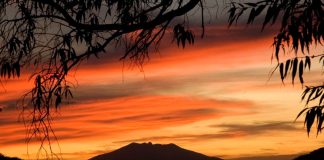 The sun sets behind Tequila Volcano.
