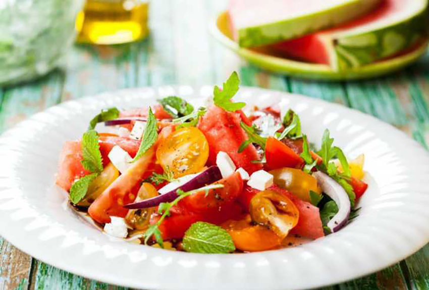 A summer salad of watermelon and tomato.