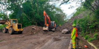 Workers clear a slide in Jalisco.