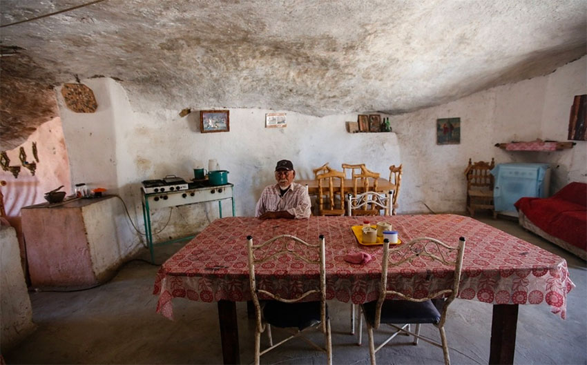 Hernández inside a room that serves as living room, kitchen and dining room.