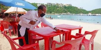 A waiter prepares a table at one of Huatulco's beaches.