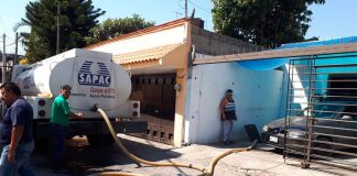 Cuernavaca's water utility makes a delivery to a home in March 2018 after electricity to the pumps was cut off.