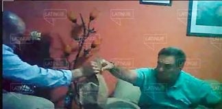 A bag of cash changes hands between León, left, and Pío López Obrador.