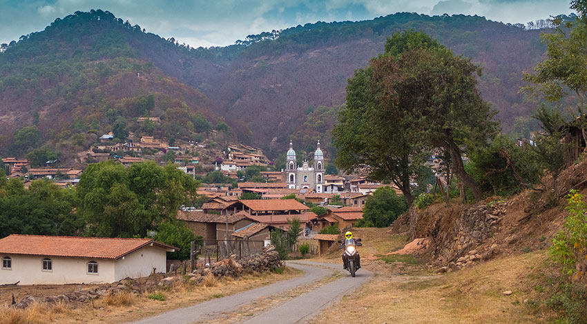 A lone biker with a picturesque backdrop.