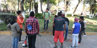 Los Varones prepare to go to work cleaning the churchyard.