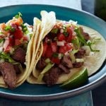 Tacos of carne asada made with an orange marinade.