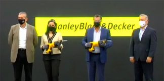 State and company officials ready to cut the ribbon—with power tools.