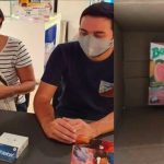 The Sears customers with their new phone and what the courier delivered.