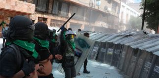 Shield-bearing police meet bare-chested protesters in Mexico City Sunday.