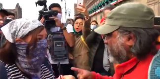 Protesters face off over graffiti.