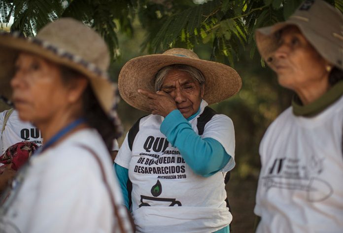 A participant wipes away tears during an international search caravan in Michoacán last year.