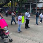 Parents block a street in Mexico City on Thursday.