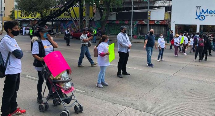 Parents block a street in Mexico City on Thursday.
