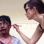 Francesca Dalla works on a zombie figure for a movie prop.