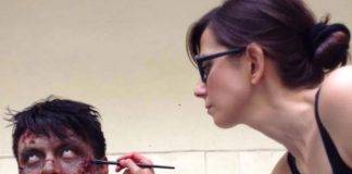 Francesca Dalla works on a zombie figure for a movie prop.