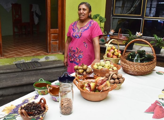 The Puebla cook and the ingredients that will go into her own version of the dish.