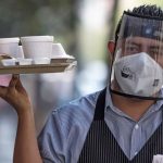 A face mask plus a shield can be a sign that the restaurant is taking Covid precautions seriously.