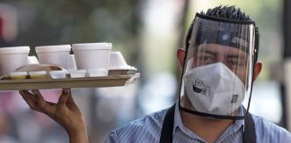 A face mask plus a shield can be a sign that the restaurant is taking Covid precautions seriously.