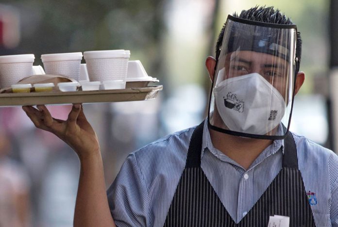 A face mask plus a shield can be a sign that the restaurant is taking Covid precautions seriously.