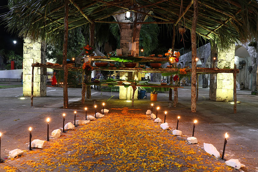 A trail of candles beckons the souls to an altar in Felipe Carrillo Puerto