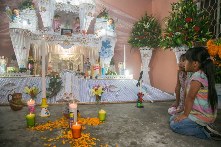 Girls at a rare three-tiered memorial altar in Huaquechula, Puebla. 