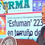 The president exhibits a front page of Reforma over a story with which he took issue, a common occurrence at his daily press conferences.
