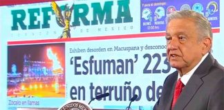 The president exhibits a front page of Reforma over a story with which he took issue, a common occurrence at his daily press conferences.
